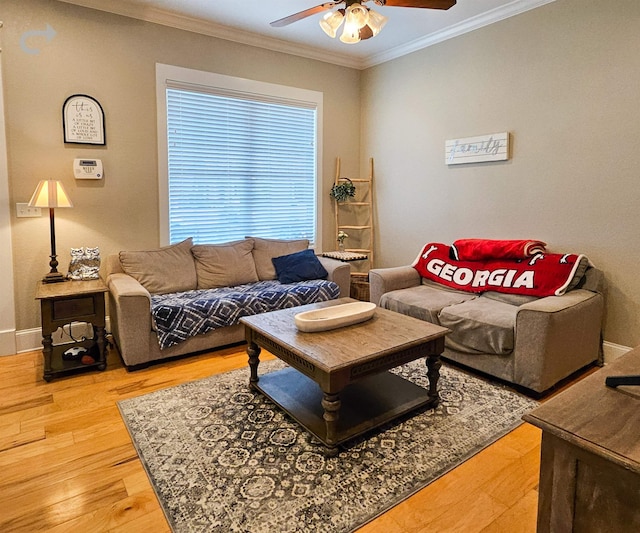 living room featuring hardwood / wood-style floors, ornamental molding, and ceiling fan