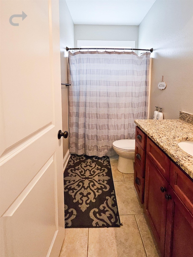 bathroom with vanity, tile patterned floors, and toilet