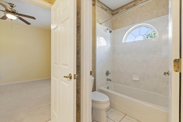 bathroom featuring ceiling fan, tiled shower / bath, toilet, and tile patterned floors