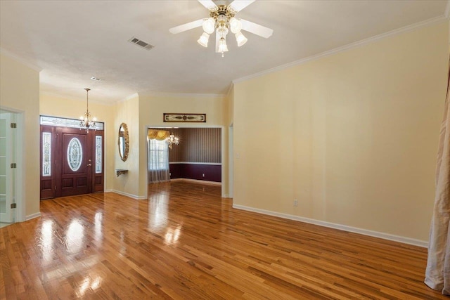 entrance foyer featuring ornamental molding, hardwood / wood-style flooring, and ceiling fan with notable chandelier