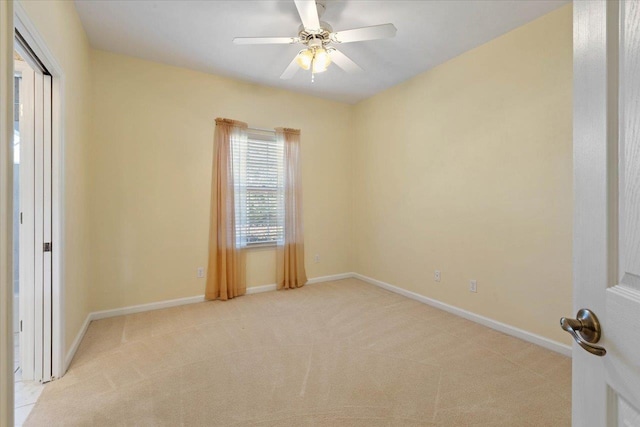 carpeted spare room with ceiling fan