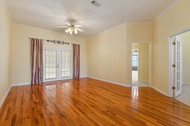 spare room with ornamental molding, wood-type flooring, and french doors