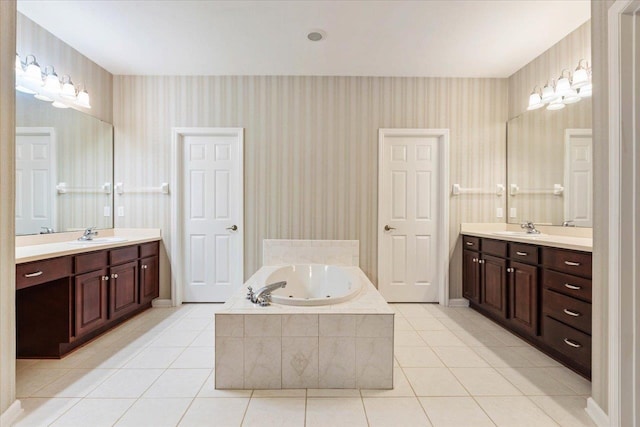 bathroom featuring vanity, tile patterned floors, and tiled bath