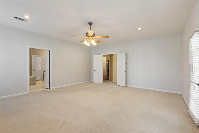 unfurnished bedroom featuring light carpet and ceiling fan