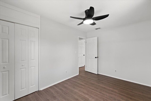 603 W Ash St, Perry, FL 32347 - unfurnished bedroom featuring dark wood finished floors, baseboards, a closet, and ceiling fan