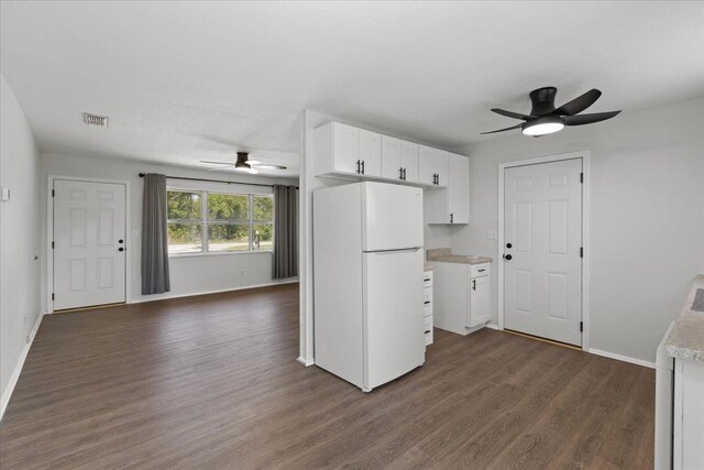 603 W Ash St, Perry, FL 32347 - kitchen featuring freestanding refrigerator, a ceiling fan, dark wood-style floors, baseboards, and white cabinetry