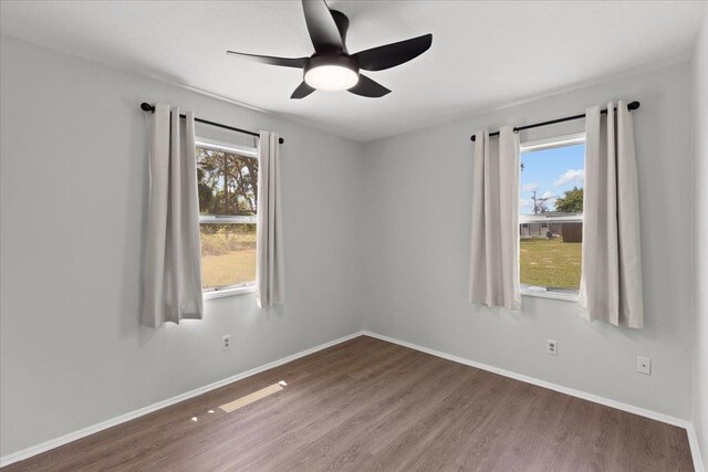 603 W Ash St, Perry, FL 32347 - spare room with wood finished floors, plenty of natural light, ceiling fan, and baseboards