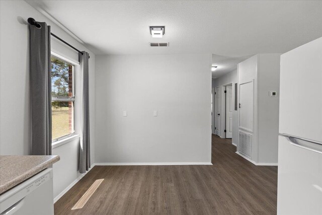 603 W Ash St, Perry, FL 32347 - unfurnished dining area featuring dark wood-type flooring and baseboards