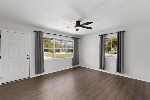 603 W Ash St, Perry, FL 32347 - empty room with a ceiling fan, dark wood-style flooring, baseboards, and a textured ceiling