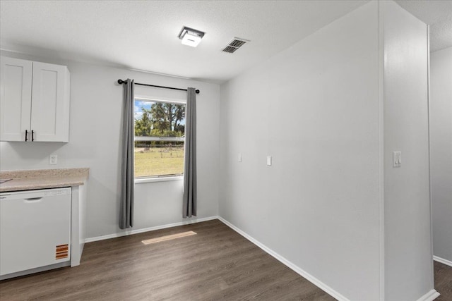 603 W Ash St, Perry, FL 32347 - unfurnished dining area featuring dark wood-style floors and baseboards