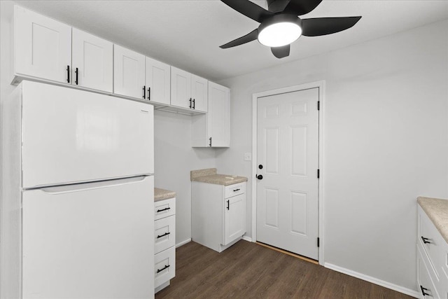 603 W Ash St, Perry, FL 32347 - kitchen with freestanding refrigerator, a ceiling fan, dark wood finished floors, white cabinetry, and light countertops
