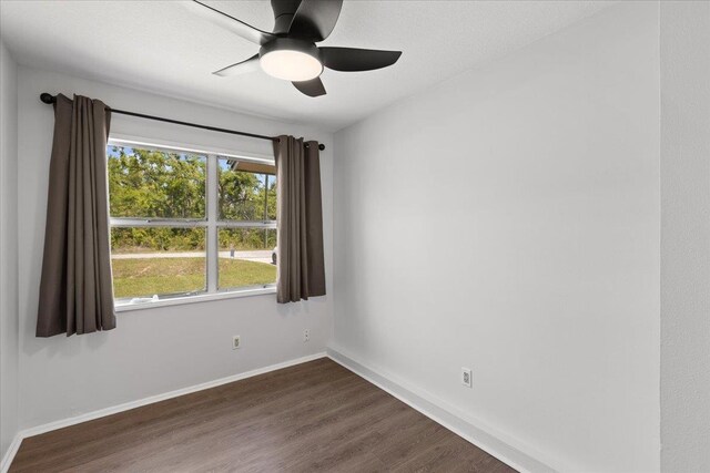 603 W Ash St, Perry, FL 32347 - spare room with dark wood-style floors, baseboards, and a ceiling fan