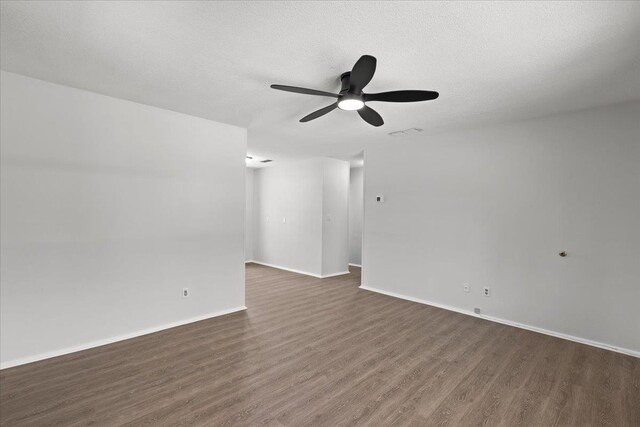 603 W Ash St, Perry, FL 32347 - spare room featuring dark wood finished floors, ceiling fan, baseboards, and a textured ceiling