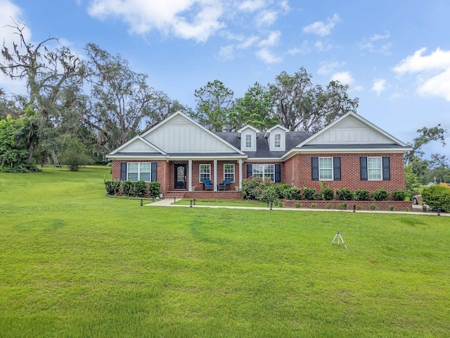 3325 Mariana Oaks Dr, Tallahassee, FL 32311 - craftsman-style house with board and batten siding, brick siding, a porch, and a front lawn