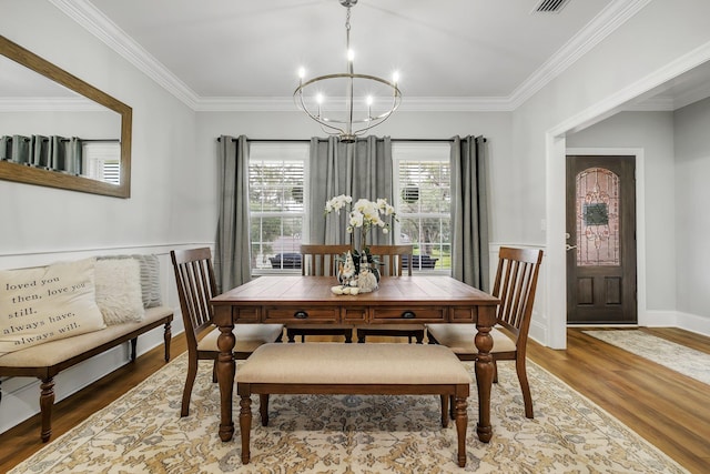 3325 Mariana Oaks Dr, Tallahassee, FL 32311 - dining space with a chandelier, wood finished floors, and crown molding
