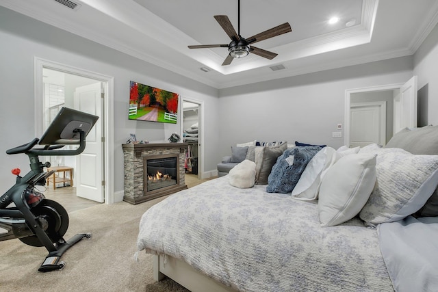 3325 Mariana Oaks Dr, Tallahassee, FL 32311 - carpeted bedroom with a raised ceiling, ornamental molding, a spacious closet, a stone fireplace, and ceiling fan