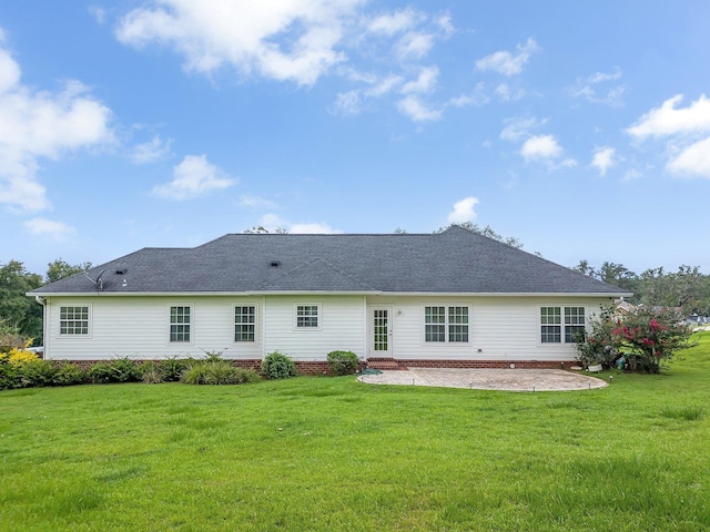3325 Mariana Oaks Dr, Tallahassee, FL 32311 - rear view of house with a patio, a lawn, and a shingled roof