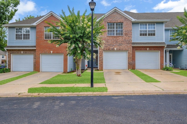 1320 Hendrix Rd Unit 403, Tallahassee, FL 32301 - view of front facade with a garage, brick siding, and concrete driveway