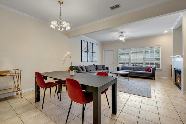 1320 Hendrix Rd Unit 403, Tallahassee, FL 32301 - dining area featuring a chandelier, light tile patterned floors, a glass covered fireplace, ornamental molding, and a ceiling fan