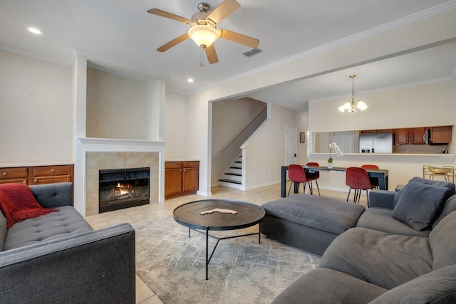 1320 Hendrix Rd Unit 403, Tallahassee, FL 32301 - living room with light tile patterned floors, stairway, ornamental molding, a ceiling fan, and a tile fireplace