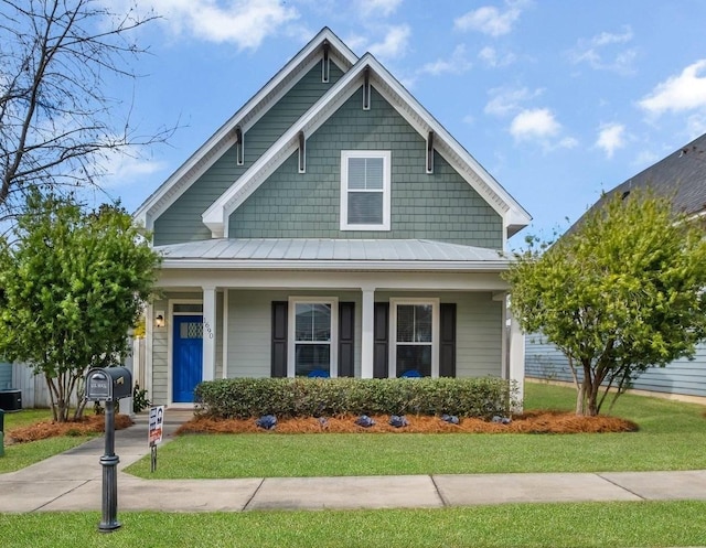 view of front of property with a front yard and covered porch