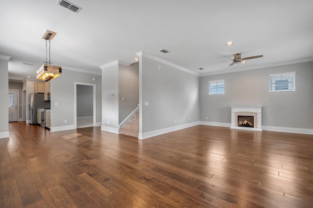 unfurnished living room featuring crown molding, dark hardwood / wood-style floors, and ceiling fan