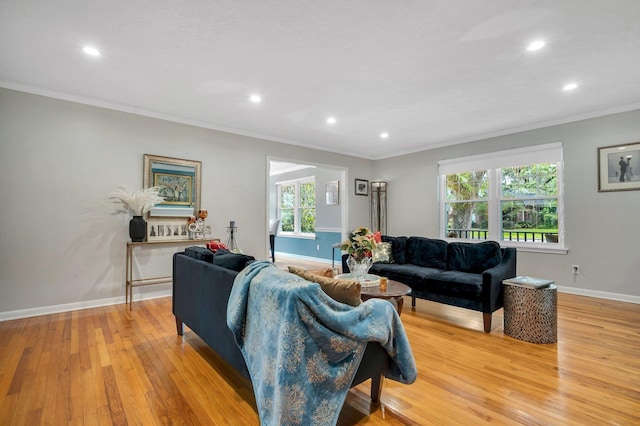 living room with light wood-style flooring, crown molding, recessed lighting, and baseboards
