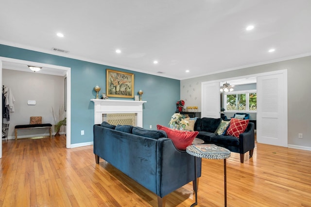 living room with ornamental molding, light wood finished floors, recessed lighting, a fireplace, and baseboards