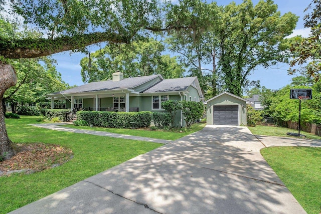 view of front facade featuring driveway, covered porch, a detached garage, and a chimney