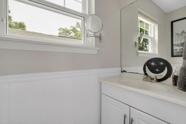 bathroom featuring a wainscoted wall and vanity