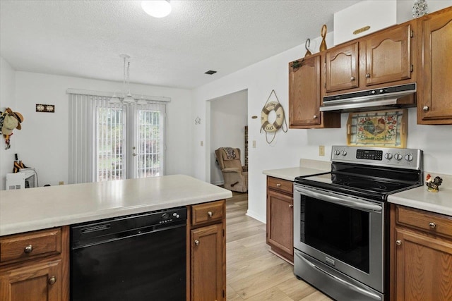 kitchen featuring stainless steel range with electric stovetop, a textured ceiling, decorative light fixtures, dishwasher, and light hardwood / wood-style flooring