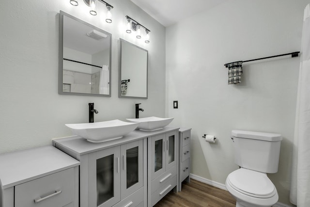 2121 Shadyoaks Dr, Tallahassee, FL 32303 - bathroom with wood finished floors, double vanity, and a shower with shower curtain