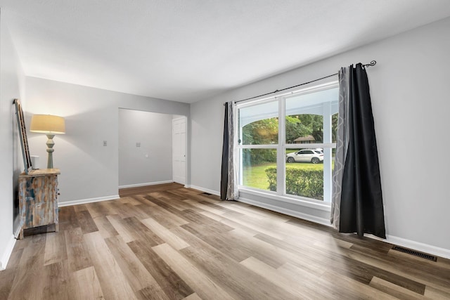 2121 Shadyoaks Dr, Tallahassee, FL 32303 - unfurnished living room with light wood-type flooring and baseboards