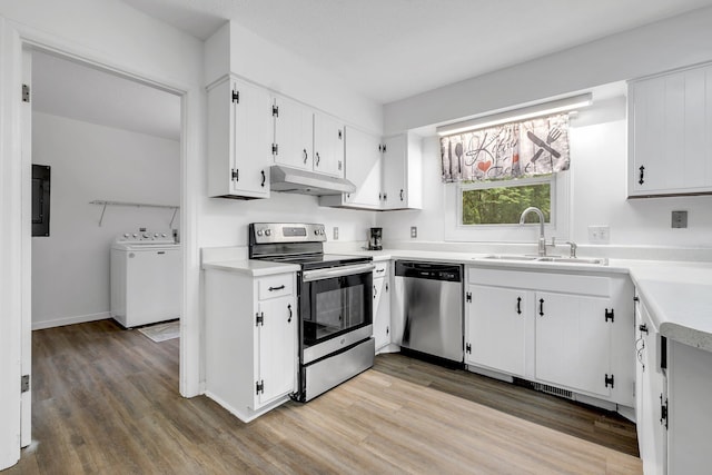 2121 Shadyoaks Dr, Tallahassee, FL 32303 - kitchen featuring appliances with stainless steel finishes, under cabinet range hood, washer / clothes dryer, and light wood-style flooring