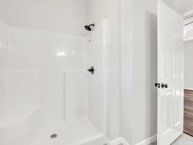 bathroom featuring hardwood / wood-style flooring and a shower