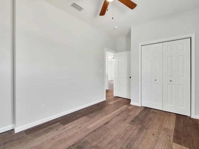 unfurnished bedroom with wood-type flooring, a closet, and ceiling fan