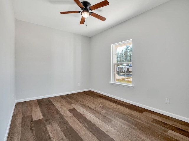 empty room with hardwood / wood-style flooring and ceiling fan