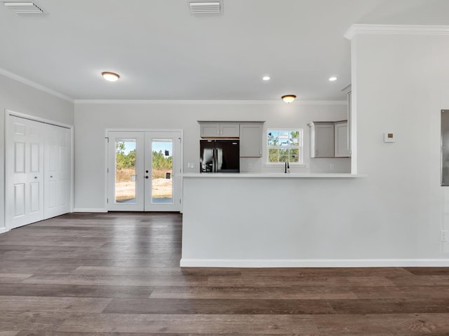 kitchen with french doors, dark hardwood / wood-style flooring, black fridge, ornamental molding, and gray cabinets