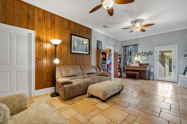 1165 Dills Rd, Monticello, FL 32344 - living area with ceiling fan, crown molding, wood walls, and stone tile flooring