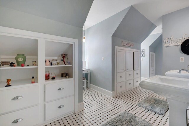1165 Dills Rd, Monticello, FL 32344 - bathroom featuring vaulted ceiling, baseboards, a sink, and tile patterned floors