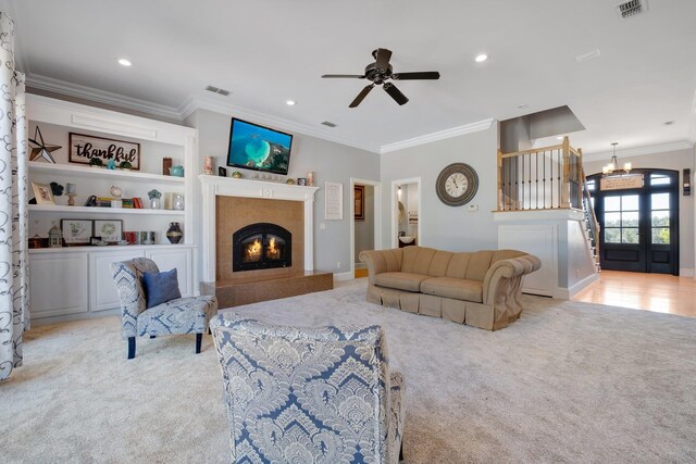 1165 Dills Rd, Monticello, FL 32344 - living area featuring light colored carpet, crown molding, a chandelier, ceiling fan, and a premium fireplace
