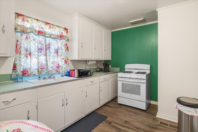 kitchen featuring visible vents, white gas range, light countertops, and white cabinetry