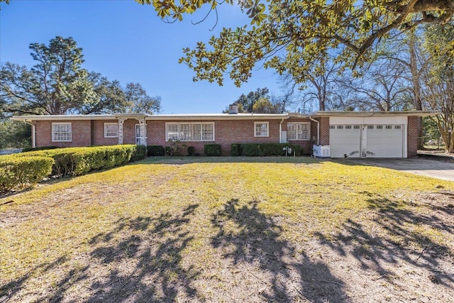 ranch-style house featuring a front lawn, an attached garage, brick siding, and driveway