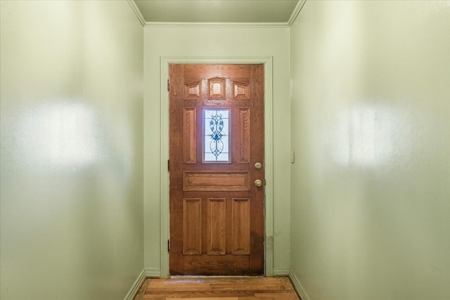 doorway to outside featuring baseboards and ornamental molding