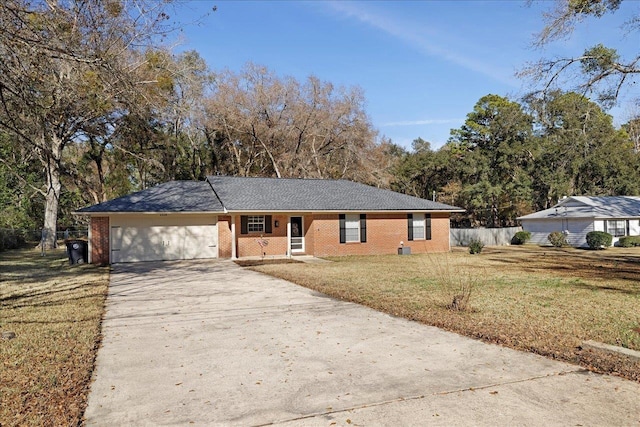 ranch-style home with a garage and a front yard