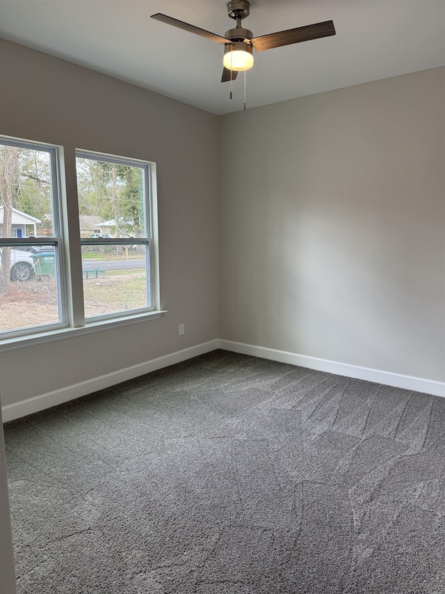 empty room featuring ceiling fan, carpet floors, and baseboards