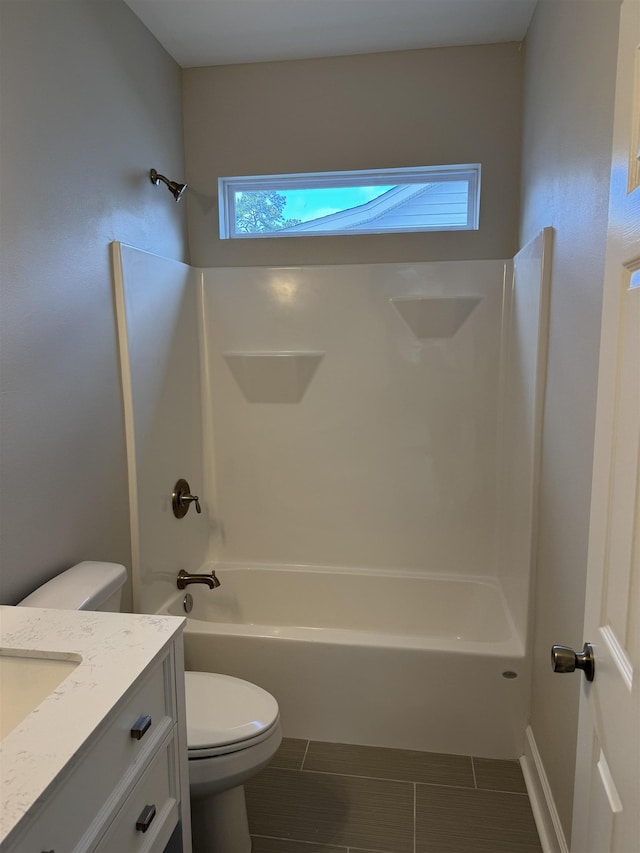 bathroom with shower / washtub combination, vanity, and toilet