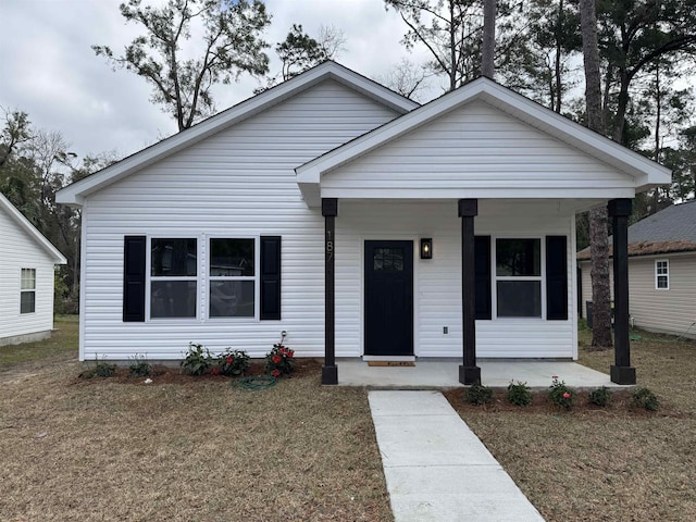 bungalow with a porch and a front lawn