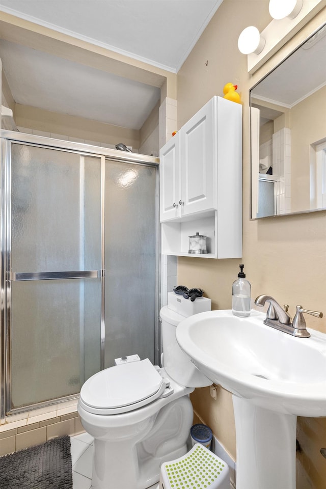 full bath with a stall shower, toilet, and tile patterned floors