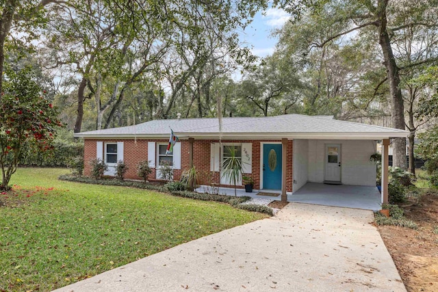 ranch-style home with driveway, brick siding, a carport, and a front yard